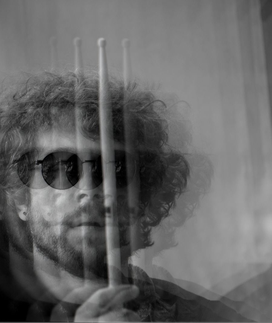 Joe Heeb holding a pair of drumsticks, black and white